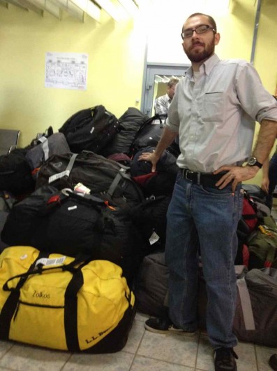 Clark University PhD student Dave Mayer leans on the pile of bags in Yakutsk, Russia. 
