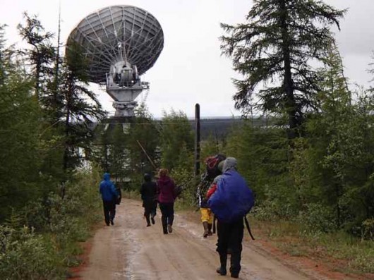 Polaris Project students carry gathered wood toward Orbita – where I am staying.