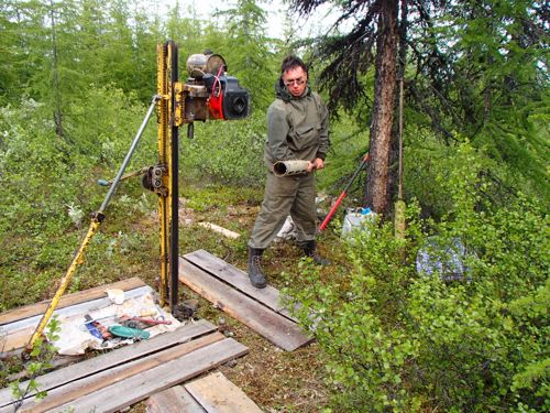 Dr. Alexander (Sasha) Kholodov carries a bore hole bit toward the drilling rig.