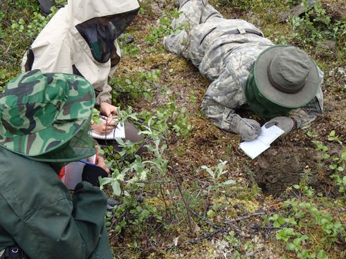 Varvara, Dylan, and Dr. Valentin Spektor (L to R) make observations of the pit.