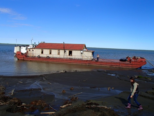 Nastya Zimova steps quickly across the mud flats to avoid sinking.