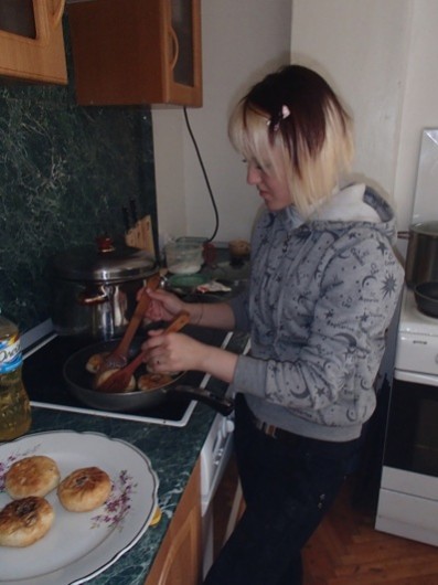 Yuliya (Julia) Igoreva cooks the moose meat pies on the stove.