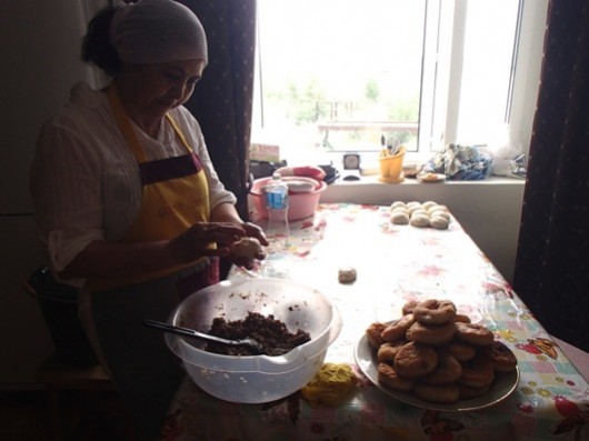 Khalida Dautova stuffs the fresh homemade dough with the moose meat filler.