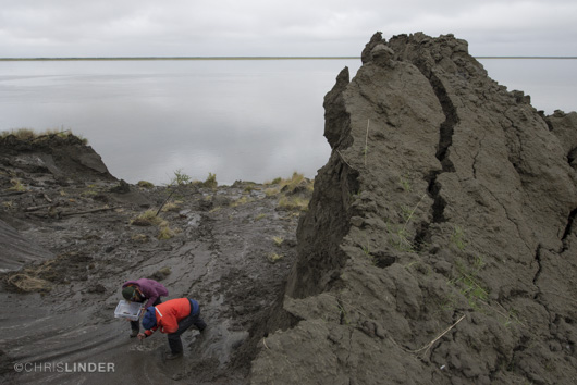 Kelsey Dowdy (left) and Rob Spencer carve out ice wedge samples at Duvannyi Yar