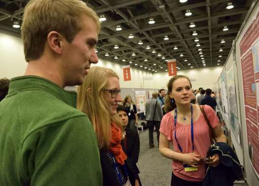 Seth Spawn, Erin Seybold, and Megan Behnke at Megan's poster. Photo by John Schade.