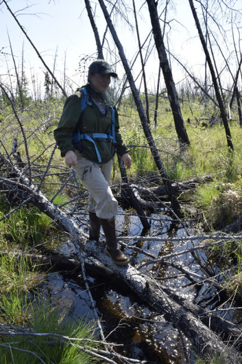 Kenzie Kuhn with a pond formed by land subsidence. © John Schade