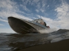 The rivers team drives a small boat on the Kolyma River.