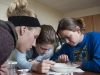 Erin Seybold, Moira Hough, and Kayla Henson pick through a lake sediment sample.