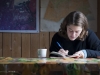 Moira Hough writes in her journal on the barge.