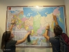 Kayla Henson and Max Janicek point at all of the stopping points on the 2009 flight route to Cherskiy.